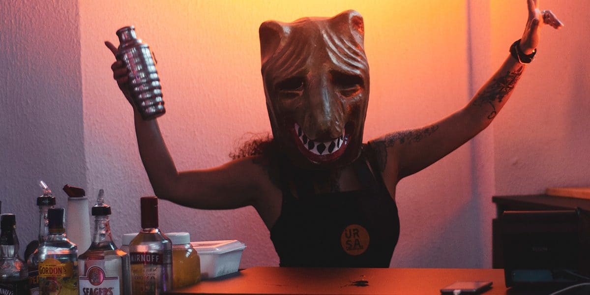 karneval-kostueme Es ist Zeit für Verkleidungen! Karnevalistin mit einer Wolfsmaske mixt einen Cocktail.