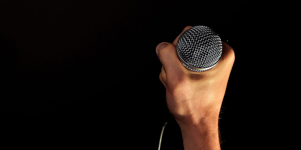 Eine Hand hält ein Microfon